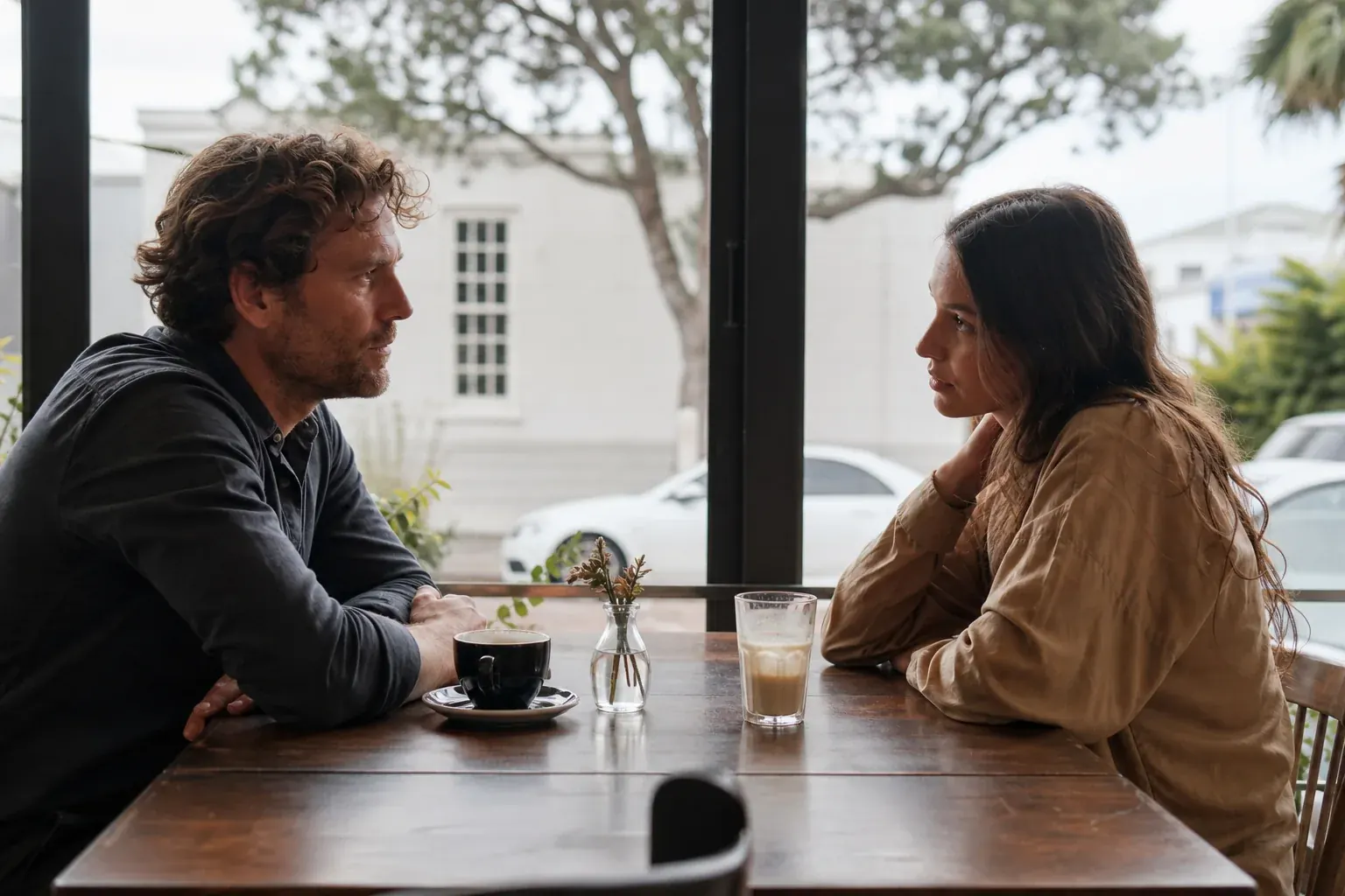 Two former partners having a difficult conversation in a cafe